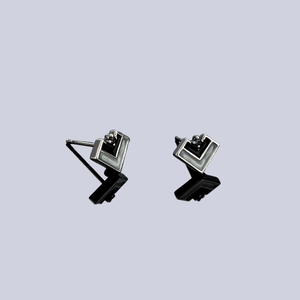 Minimalist geometric V-shaped earrings in polished silver with grey enamel and dark stones