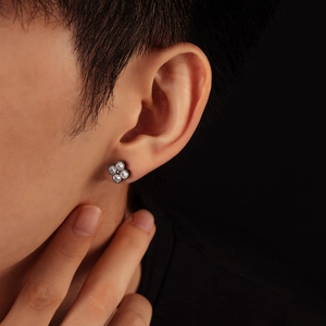 Minimalist four-leaf clover stud earring with clear crystals on male model ear