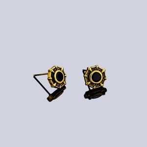 Golden eight-pointed star stud earrings with black stone inlay on reflective background