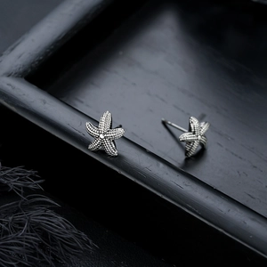 Textured starfish stud earrings in vintage silver finish with realistic nautical details