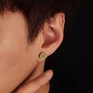 Retro round dragon stud earring in silver and gold, shown worn on a model's ear