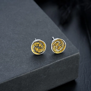 Detailed view of vintage double dragon stud earrings with gold and silver dual-tone finish