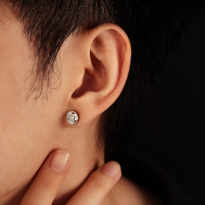 Close-up of barbell weight plate earring with 10KG engraving and sparkling zircon