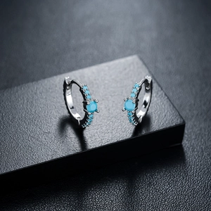 Silver huggie earrings with bright turquoise round stones and fine micro-pave settings