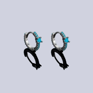 Minimalist silver hoop earrings with blue turquoise stones and polished finish