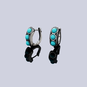 Vintage oxidized silver earrings featuring triple turquoise stone inlay in hinged hoop style