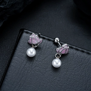 Macro detail of lotus flower stud earrings with white pearls and secure screw backings