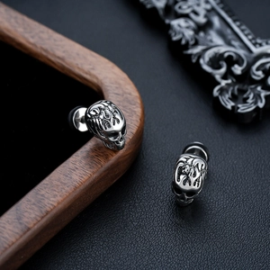 Retro punk style skull stud earrings in silver metal with vintage black texture finish