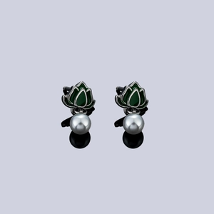 Vintage lotus studs with green petals and hanging pearls on a reflective background