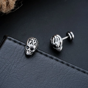 Gothic skull stud earrings in vintage silver finish with a flaming hollow design