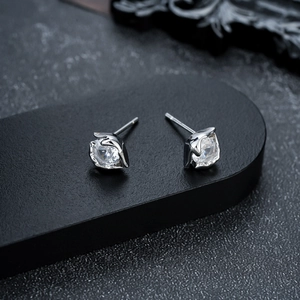 Macro detail of silver evil eye stud earring with sparkling cubic zirconia in claw setting