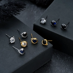 Polished steel eye stud earrings with colorful zircon stones in silver, gold, and black finishes