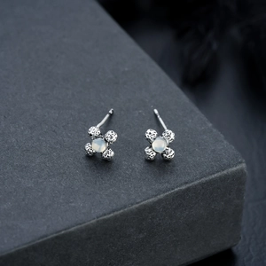 Floral moonstone stud earrings with vintage silver cross design and matte finish