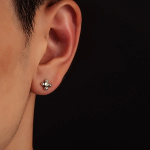 Vintage flower moonstone stud earring in sterling silver worn on a male earlobe