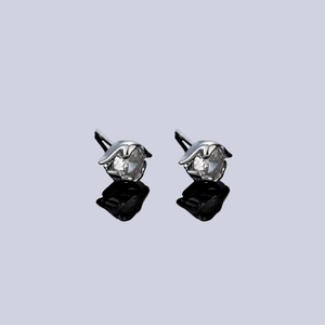 Silver evil eye stud earrings with round clear stones and claw setting on reflective base