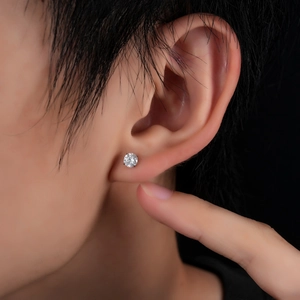 Titanium stud earring with round cubic zirconia on earlobe for men and women