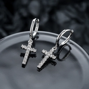 Gros plan sur des boucles d'oreilles croix en argent S925 pavées de zircons blancs