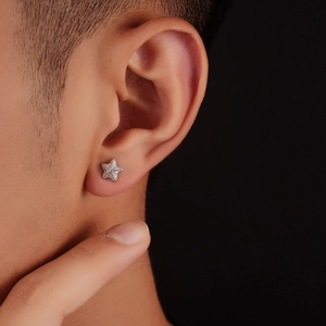 Stereo star stud earrings with white zircons on male ear model with black background
