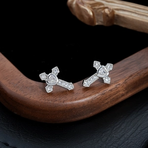 Cross earrings with heart zircon and micro-pave diamonds on black leather background