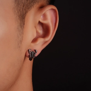Retro punk style scorpion stud earring in gun-black metal finish worn on male ear lobe