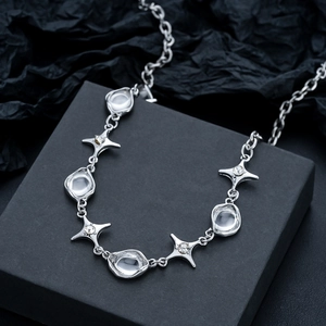 Modern starburst necklace with zircon stones on a black gift box, silver jewelry aesthetic