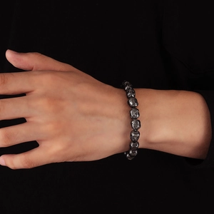 Polished gunmetal hematite Buddha bead bracelet on wrist for a minimalist stylish look