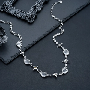 Elegant silver starburst necklace with irregular zircon stones and glass beads on stone base