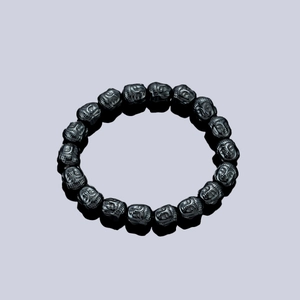 Magnetic hematite Buddha head bead bracelet featuring 18 polished black carved beads
