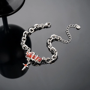 Detail of snake serpent around red rectangle gem on punk style silver black chain bracelet