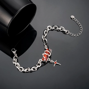 Detail of punk stainless steel chain with red gemstone and star pendant charm