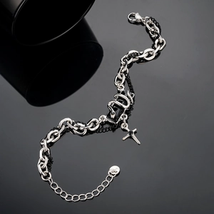 Detail of double-layer snake and cross bracelet with silver chain and black beads