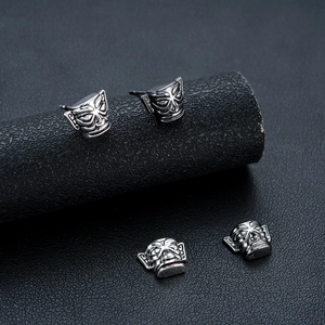 Vintage Sanxingdui mask earrings in polished silver alloy with tribal relief patterns