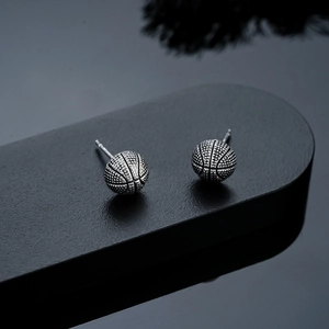 Macro detail of basketball stud earring with vintage textured finish and fine stitching