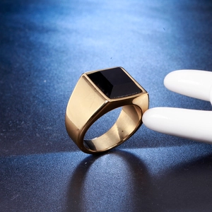 Macro detail of men's stainless steel signet ring with square black stone inlay