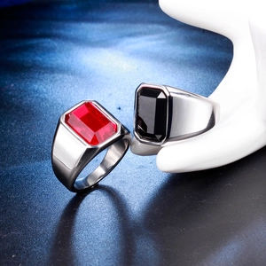 Detail of wide stainless steel rings with red and black rectangular zircon stones