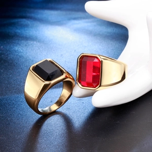 Macro detail of men's gold plated stainless steel rings with red and black square stones