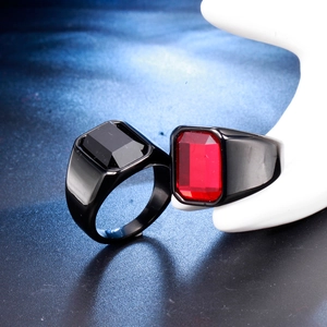 Detail of men's signet rings with red and black rectangle gemstones in black plated metal