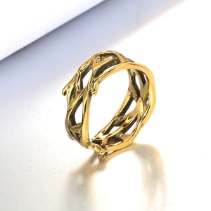 Macro shot of gold-finished thorn branch hollow ring with natural textured texture