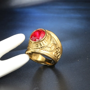 Macro shot of gold military ring with red oval stone and eagle relief details