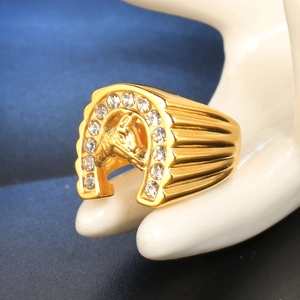 Macro shot of horseshoe ring with horse head relief and sparkling pavé crystals
