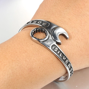 Detailed close-up of vintage industrial wrench-style cuff bracelet in silver finish