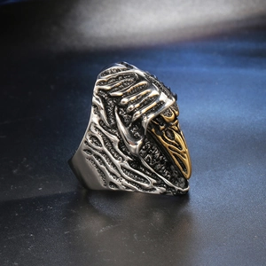 Detailed close-up of a retro eagle head ring with golden beak and silver feathers