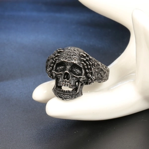 Retro gothic skull ring in vintage stainless steel finish on a hand display