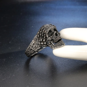 Macro view of vintage gothic skull ring with detailed oxidized metal texture and rock pattern