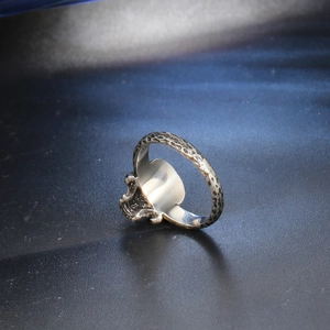 Macro view of vintage skull ring with hammered steel texture and gothic relief details