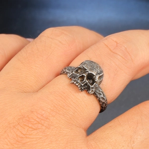 Vintage stainless steel skull ring with realistic bone texture and oxidized finish