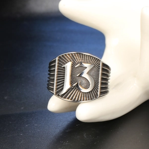 Vintage stainless steel ring with gothic number 13 and decorative radial patterns