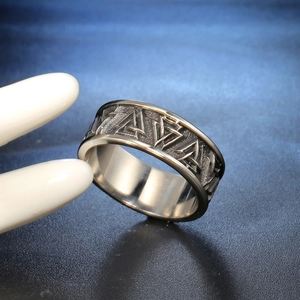Macro view of vintage stainless steel ring with embossed Viking Valknut patterns