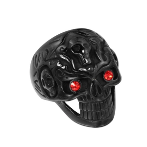 Gothic punk black stainless steel skull ring with red rhinestone eyes on white background