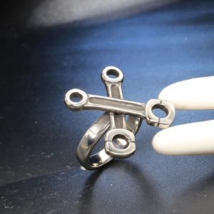 Detailed macro view of industrial style crisscross wrench ring in retro silver steel